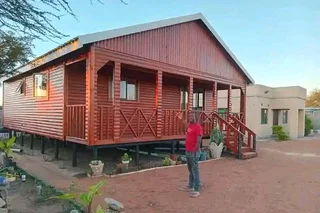 Log Home 11m×8m with 2 Bedrooms, 2 Bathrooms, Open plan Kitchen area, Lounge area and Balcony.