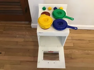 Children’s toy oven stove with pots and pans