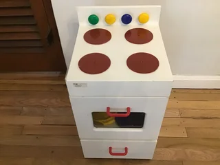 Children’s toy oven stove with pots and pans