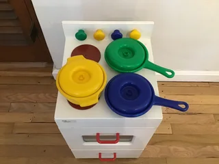 Children’s toy oven stove with pots and pans