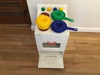 Children’s toy oven stove with pots and pans
