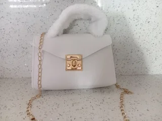 White handbag with a fur strap in stock