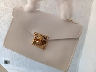 White handbag with a fur strap in stock