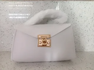 White handbag with a fur strap in stock