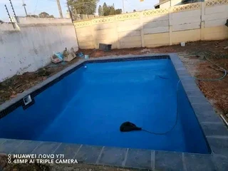 Swimming pool and concrete driveway