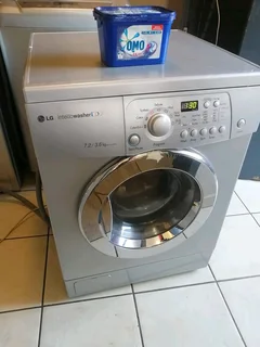 SILVER LG DIRECT DRIVE FRONT LOADER WASHER AND DRYER COMBO MACHINE