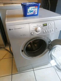 SILVER LG DIRECT DRIVE FRONT LOADER WASHER AND DRYER COMBO MACHINE