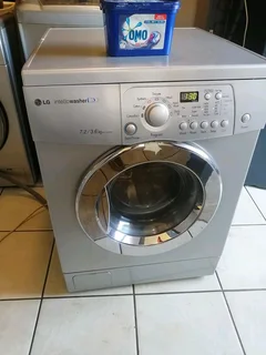 SILVER LG DIRECT DRIVE FRONT LOADER WASHER AND DRYER COMBO MACHINE