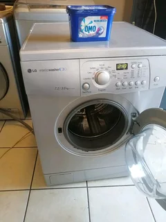 SILVER LG DIRECT DRIVE FRONT LOADER WASHER AND DRYER COMBO MACHINE