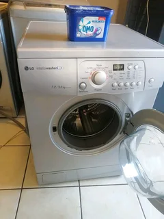 SILVER LG DIRECT DRIVE FRONT LOADER WASHER AND DRYER COMBO MACHINE