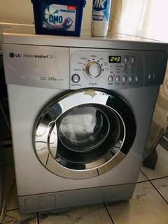 SILVER LG DIRECT DRIVE FRONT LOADER WASHER AND DRYER COMBO MACHINE