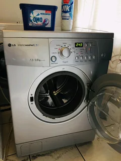 SILVER LG DIRECT DRIVE FRONT LOADER WASHER AND DRYER COMBO MACHINE