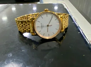 Titanium Tisso watch and a pure gold Tisso watch