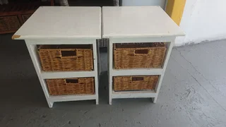 White wooden bedside tables with two woven baskets