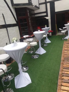 Garden Umbrellas hire. Lounge Couches and Cocktails mix set up decor. Artificial green carpet hire.