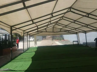 Lounge Chillas Couches set up. Outside decor with Umbrellas and Couches. Artificial carpet hire.