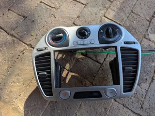 Hyundai i20 2012 model center radio panel with integrated air vent and heater control for sale.