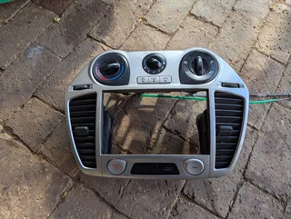 Hyundai i20 2012 model center radio panel with integrated air vent and heater control for sale.