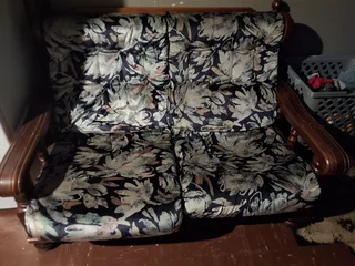 Wooden couch includes cushions