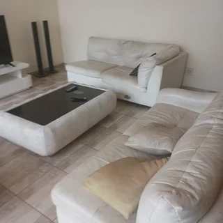 Leather couches, coffee table and tv stand