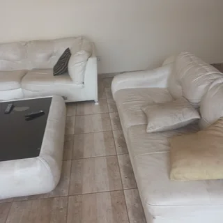 Leather couches, coffee table and tv stand