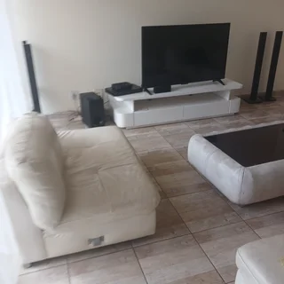 Leather couches, coffee table and tv stand