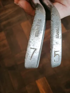 Two secondhand vintage Bogey Sun Lines Deluxe Golfclubs number 5 and 7.