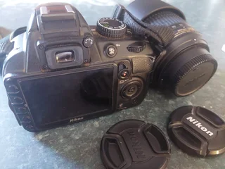 Nikon D3200 DSLR camera with extra lens, battery charger, etc.
