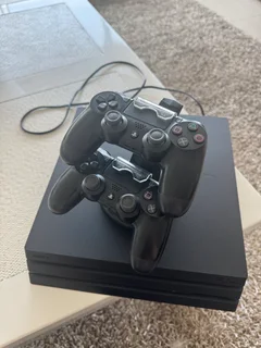 PlayStation 4 with controllers and charging station