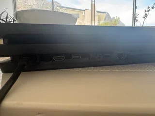 PlayStation 4 with controllers and charging station