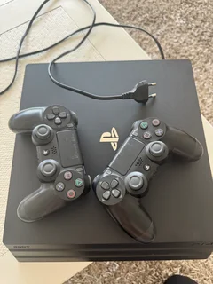 PlayStation 4 with controllers and charging station