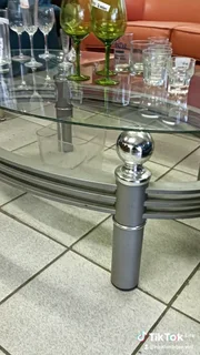 Oval glass top coffee table with aluminium frame