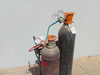Cutting torch and gas bottle set on trolley