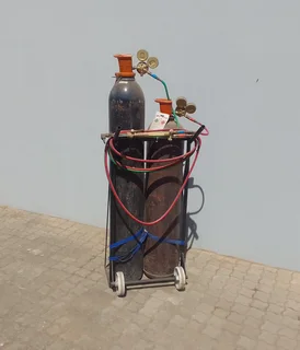 Cutting torch and gas bottle set on trolley