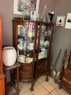 antique wooden ball and claw showcase with collectors items