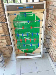 Coin operated soccer table