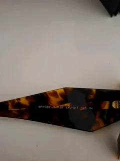 Brand new authentic Prada sunglasses in tortoiseshell frame with dark brown lenses.