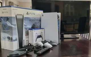 PlayStation 5 with 2 controllers and TV.