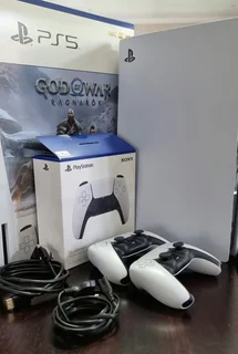 PlayStation 5 with 2 controllers and TV.
